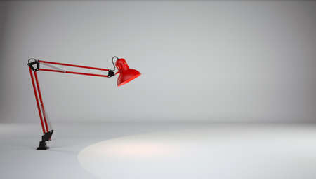 Red table lamp illuminates the floor in a gray photo studio  Art backgroundの写真素材