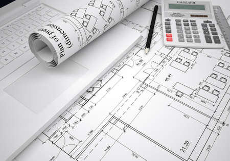 Scrolls of architectural drawings and laptop  The desk architect
