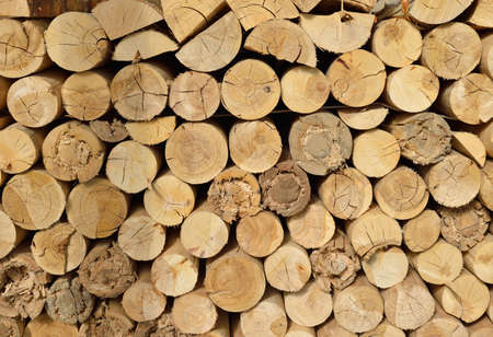 Wood chopped firewood stacked on the stack  Natural background