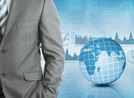 Businessman in a suit with background of Earth and graphics  Business conceptの写真素材