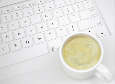 Coffee cup on the keyboard  View from aboveの写真素材