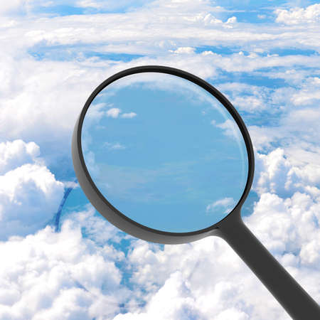 Magnifying glass looking sky in background  View from above the cloudsの写真素材