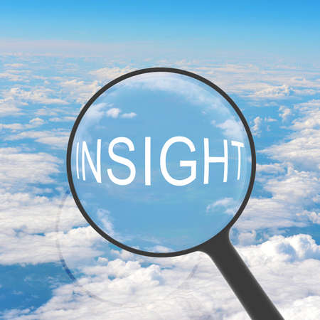 Magnifying glass looking INSIGHT  Clouds on background  Business conceptの写真素材