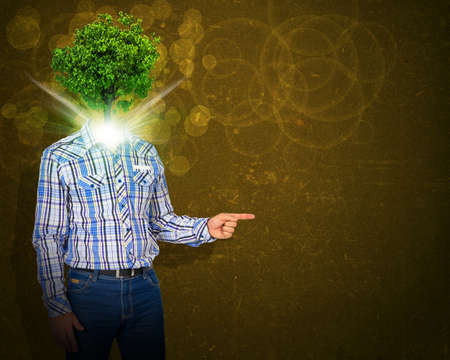 Man stand with green tree instead his headの写真素材