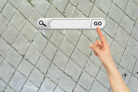 Human hand indicates the search bar in browser