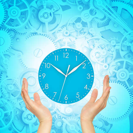 Hands hold clockの写真素材