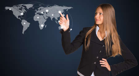 Businesswoman in a suit presses the virtual world map