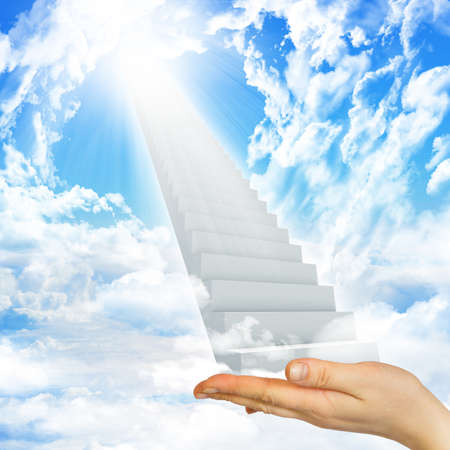 Hand hold stairs in sky with clouds and sun. Concept backgroundの写真素材