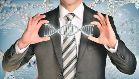 Businessman holding dna spiral in hands