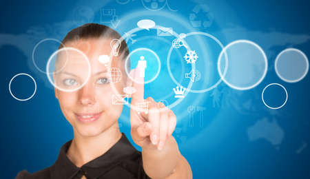 Beautiful businesswoman in dress finger presses virtual button