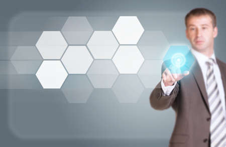 Businessman in suit finger presses virtual buttonの写真素材