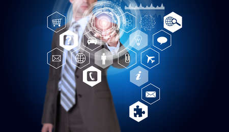 Businessman in suit finger presses virtual button