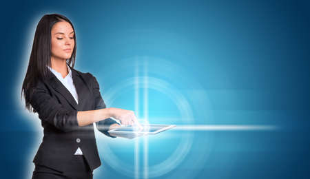 Beautiful businesswomen in suit using digital tabletの写真素材