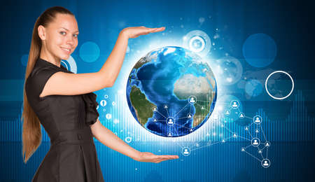 Beautiful businesswoman holding Earth. の写真素材