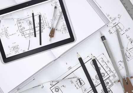 Tablet pc lying on open enpty book and engineering drawings. Tools are close by. Industrial conceptの写真素材