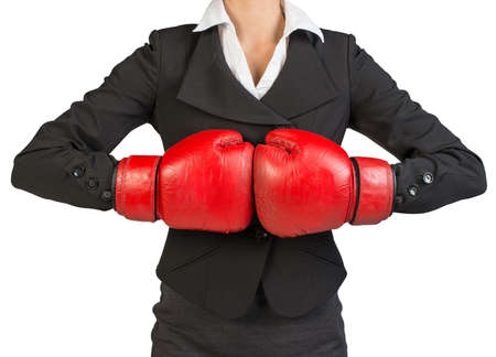 Cropped image of businesswoman in boxing gloves holding fist to fist. Isolated over white backgroundの写真素材