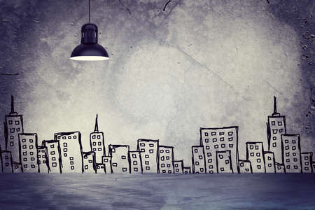 Concrete gray wall with sketches of buildings. Left standing lampshade with directional lightの写真素材