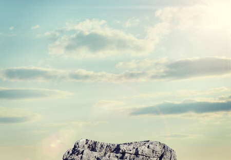 Stone on background of sky and sun