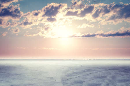 Concrete fissures surface. Sunset with fluffy cloudsの写真素材