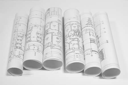 Scrolls architectural drawings on white background. Top view. Concept of buildingの写真素材