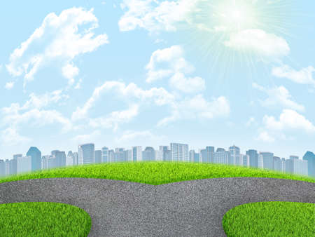 Road fork, green grass field and city. Sky with clouds in backgroundの写真素材