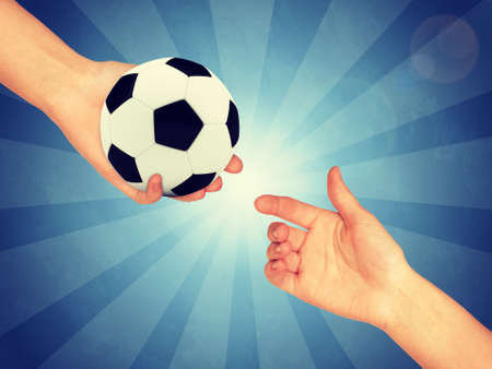 Soccer ball in hand. Abstract blue backround. Light with stripesの写真素材
