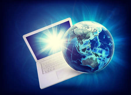 Earth model on laptop at angle on abstract blue background. 