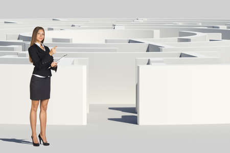 Businesswoman with folder looking at camera, near labyrinth, closed view. Isolated background, virtual modelの写真素材