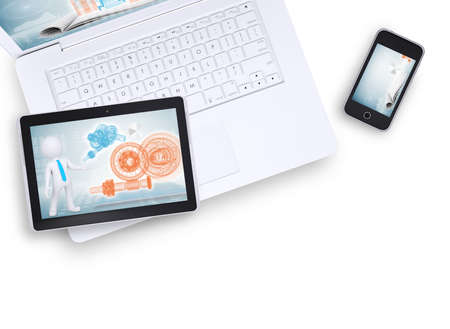 Tablet on laptop and mobile phone near on isolated white background, top view. Closed up