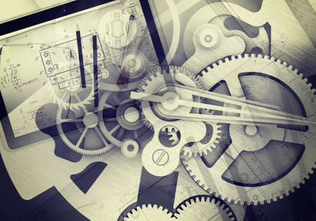 Watchwork wheels abstract background with drawing stuff, tablet, glasses, close-up viewの写真素材