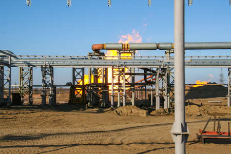 Gas and oil pipes with fire, iron construction, special placeの写真素材