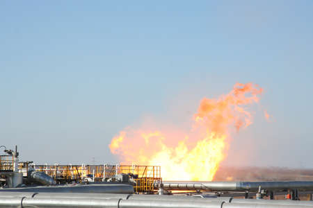 Gas and oil pipes escape with fire, iron construction, special placeの写真素材