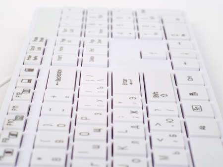 Computer keyboard on isolated white background, side view