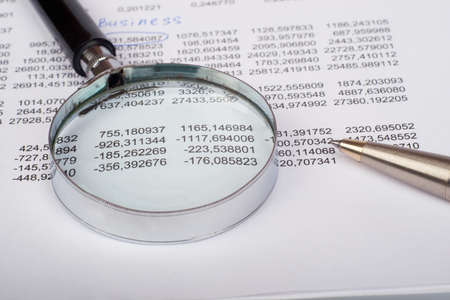 Hand glass with handle on white paper document with numbersの写真素材