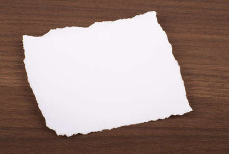 Piece of paper on brown wood tableの写真素材