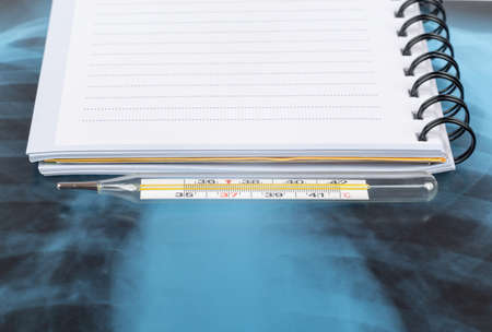 X-ray examination and copy book with thermometer, bottom viewの写真素材