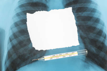 White blank piece of paper with uneven edges on X-ray examination with thermometer