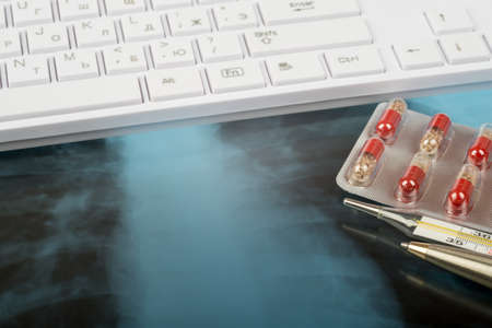X-ray examination and keyboard with thermometer, drugsの写真素材