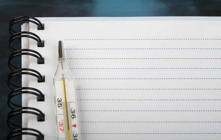 X-ray examination and copy book with thermometer, bottom viewの写真素材