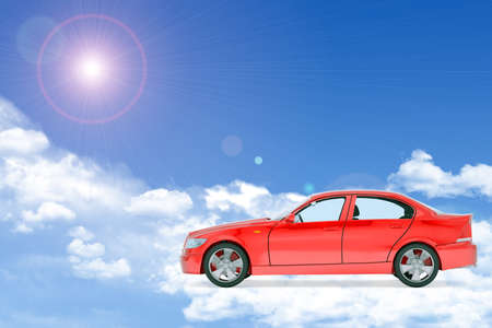 Red car on blue sky background with cloudsの写真素材