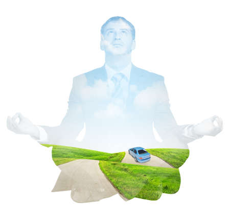 Transparent silhouette of businessman with road and car sitting in lotus posture and looking up on isolated white backgroundの写真素材