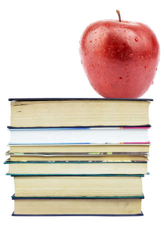 Fresh apple on pile of books on isolated white backgroundの写真素材