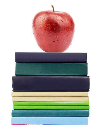Red apple on pile of books on isolated white backgroundの写真素材
