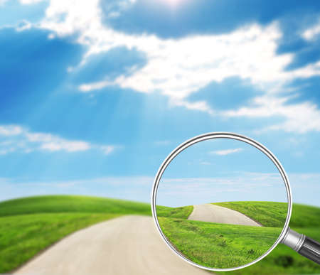 Road under loupe on nature landscape backgroundの写真素材