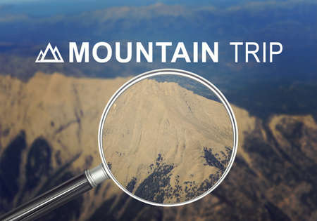 Mountain under magnifier with words mountain tripの写真素材