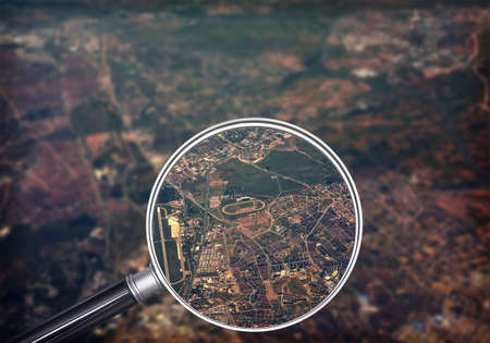 Cityscape under magnifier, close-up view, nature backgroundの写真素材