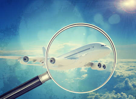 Jet under magnifier on blue sky background, close-up viewの写真素材