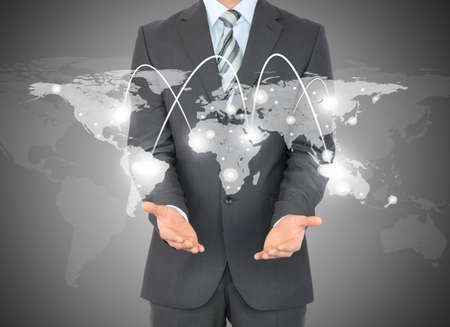 Businessman with world map in hands on abstract blue backgroundの写真素材