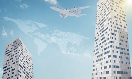 Two business center with and world map on blue sky backgroundの写真素材