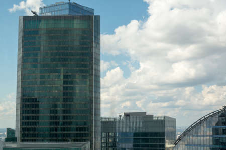 High-rise buildings on blue sky background with cloudsの写真素材